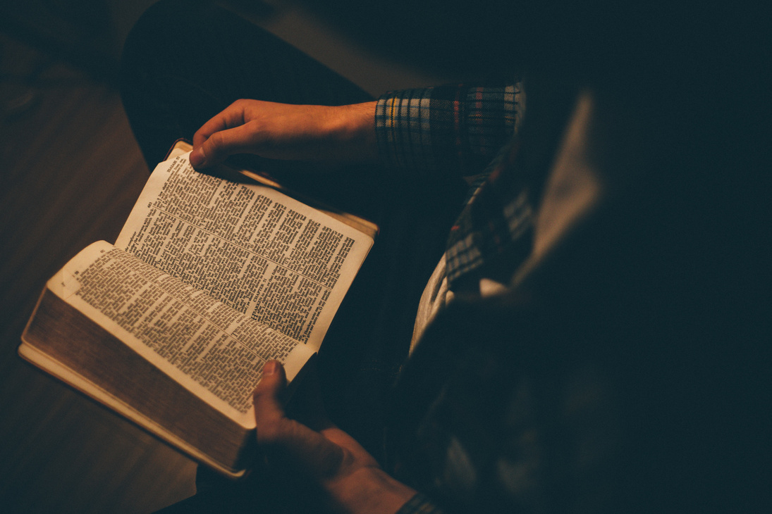 Man Sitting and Reading the Bible